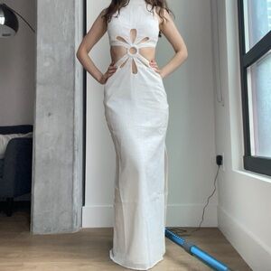 White cut out dress with a high neck and cut out details.